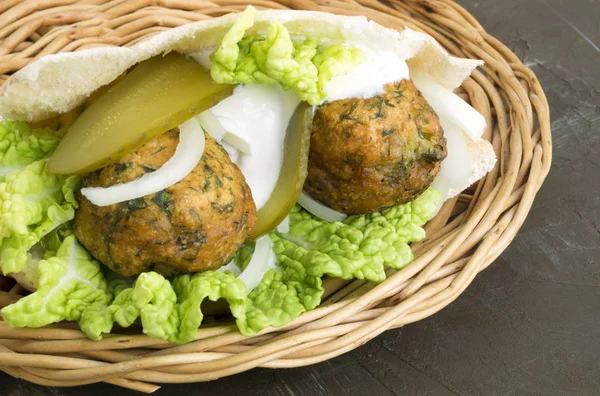 Arabic food. Hummus and falafel on a gray background.