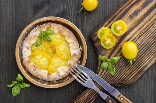 yellow tomato pie on a wooden Board.