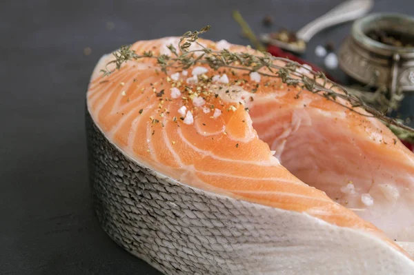 Salmon steak raw fish prepared for cooking. Top view on black ta — Stock Photo, Image