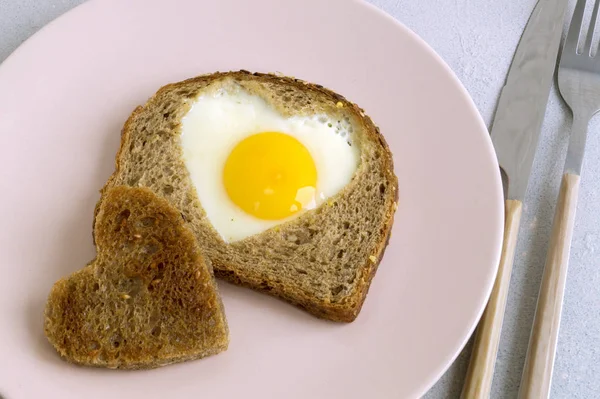 Frukost för alla hjärtans dag. ägg och rostat bröd i form av en h — Stockfoto