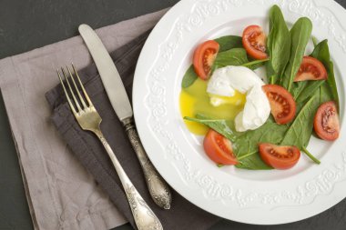 healthy diet. Medium boiled egg with fresh spinach.