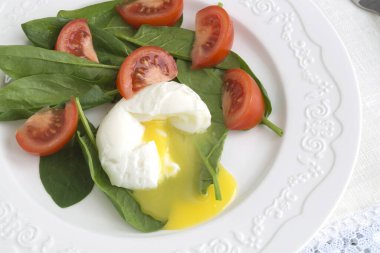 healthy diet. Medium boiled egg with fresh spinach.