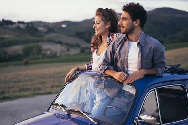 Young couple trip with vintage car