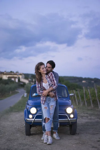 Young couple trip with vintage car