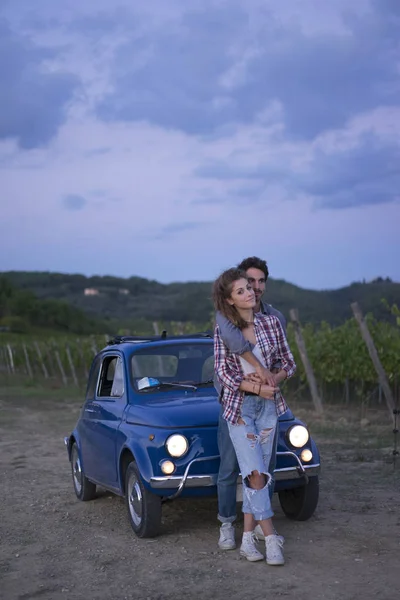 Young couple trip with vintage car