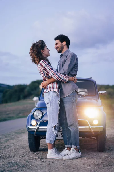 Young couple trip with vintage car