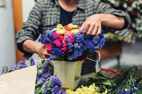florist creating bouquet in flower shop