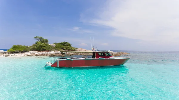 Blue water and Motor recreation boats on the tropical beach in t