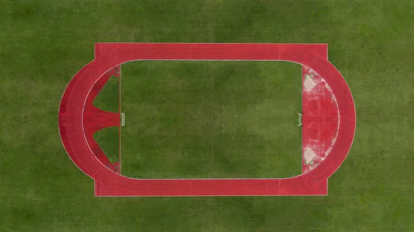 Vista aérea do campo de futebol com pista de corrida sobre o gre — Fotografia de Stock