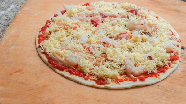 Seafood pizza on wood board — Stock Photo, Image