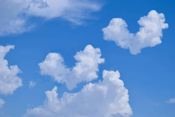 blue sky with heart clouds background