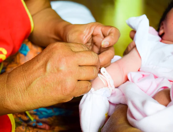 Grandma thread that tied the hands and pray,Thai baby Culture — Stock Photo, Image