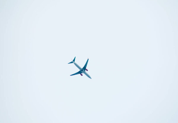 aeroplane flying on white sky background