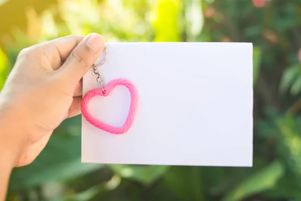 pink heart and hand with blank paper for texture for valentine \'s day.Love concept.