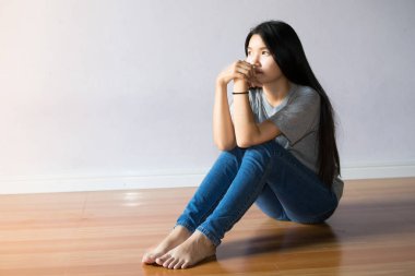 Yalnız boş bir odada oturan üzgün kadın