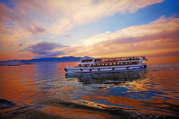 Water bus  transferring passengers in city, amazing sunset