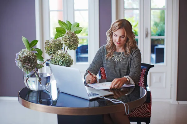 Women at her bright cozy and beautiful home-office working on desk with laptop. — Stock Photo, Image