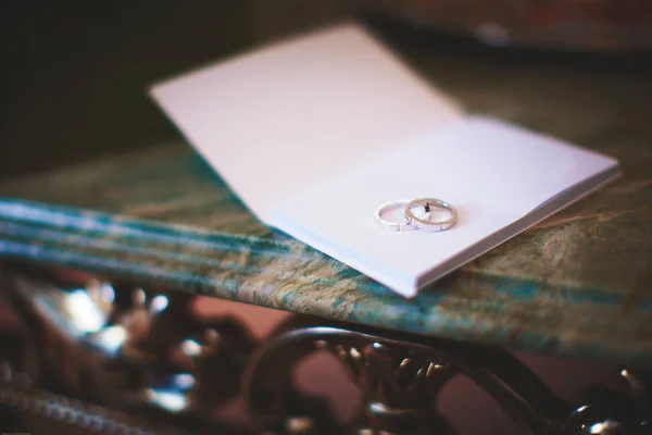 Δαχτυλίδια λευκόχρυσου γάμου σε ξενοδοχείο notebook — Φωτογραφία Αρχείου