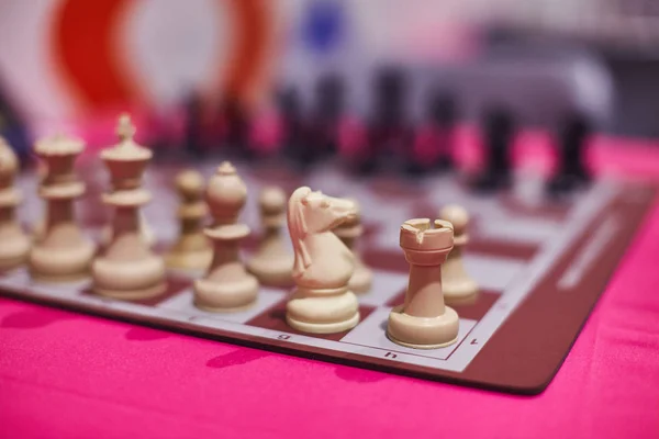 Chess tournament tables with chess timers and blank note papers