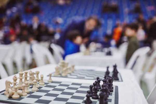 Chess tournament tables with chess timers and blank note papers