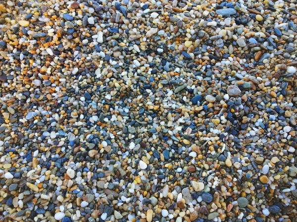 Pedrinhas coloridas na textura da praia — Fotografia de Stock