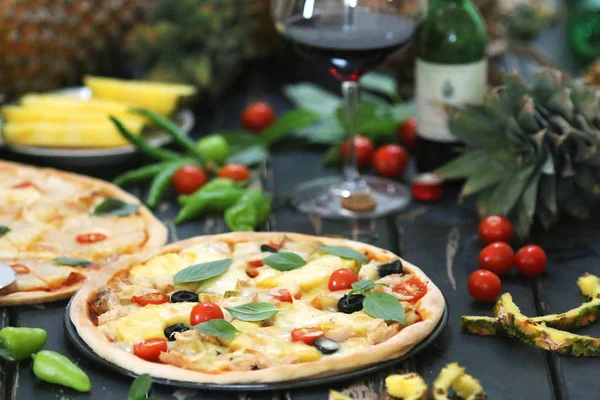 Pineapple pizza served with wine