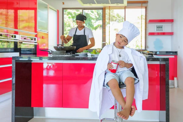 Tatlı Tay çocuğu şefin şapka ve yüksek c üzerinde oturan tunik