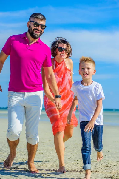 Aile üç çalışan ve tropik sahil boyunca la atlama