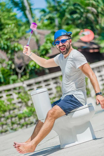 Gözlük installe olan tuvalet, ata biner gibi sakallı adam