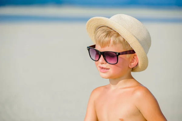 Portrait of a handsome seven years old boy on the desert sunny b — Stock Photo, Image