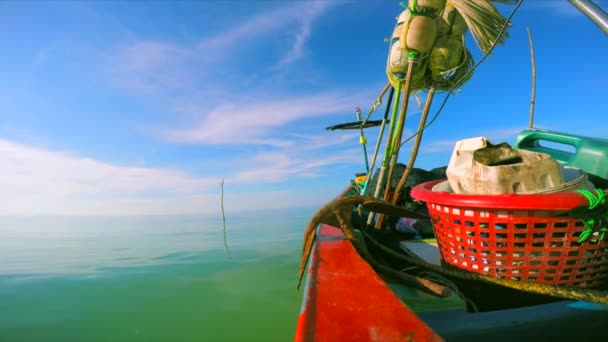 Wooden fishing boat in the sea with a big rusty anchor and some baskets aboard, view from the boats railing — Stock Video