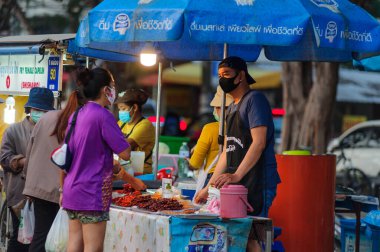Koh Samui, Tayland - 30 Mart 2020: Covid-19 ile ilişkili tehlikelere rağmen sokak satıcıları çalışmaya devam ediyor. Önlemler alınıyor: satıcıların ve müşterilerinin maskeleri, raflarda el dezenfektanı