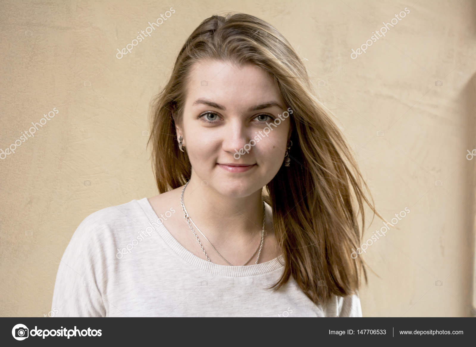 Beautiful Cute Girl On A Beige Background Without Anyone Blond