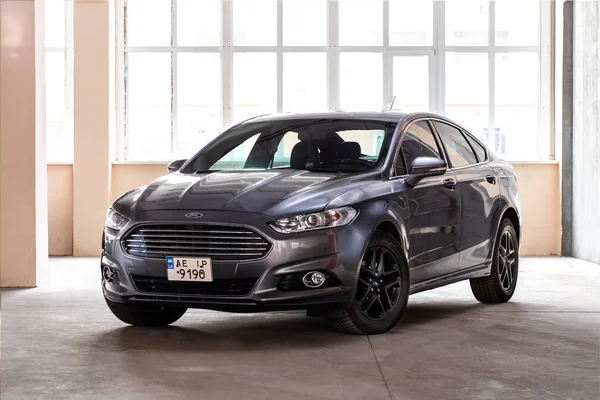 Photo of black Ford Fusion Titanium in covered parking. Stock Picture