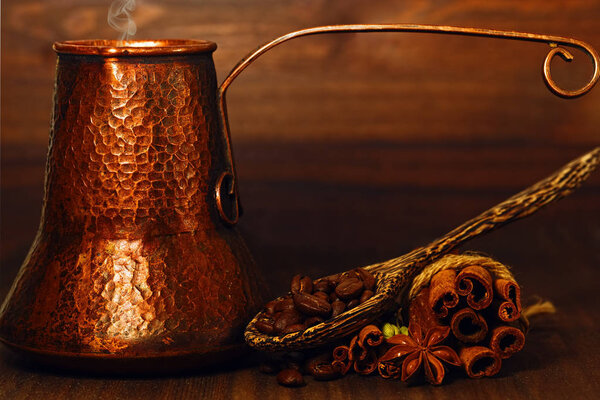 Turk coffee pot and coffee beans with spices on the table
