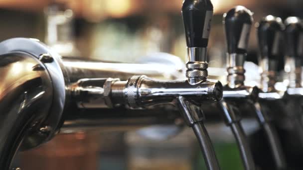 Pan shot of beer taps in a bar — Stock Video