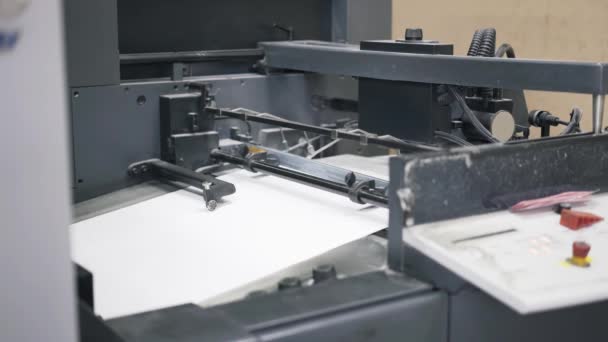 Pan shot of industrial printer making newspapers — Stock Video