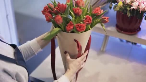 Nahaufnahme eines Blumenhändlers, der rote Blumen arrangiert — Stockvideo