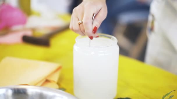 Close up de uma mulher mexendo uma mistura branca para um produto de cozinha molecular — Vídeo de Stock