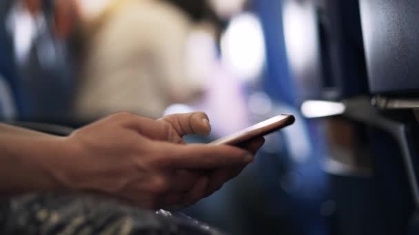 Girl s hands with a smartphone in an airplane — Stock Video