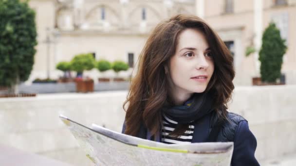 Young tourist girl looks at map in a Valencia street, Spain, Europe, close up — Stock Video