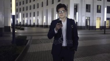 Genç işadamı web bir gece şehirde yürürken sörf