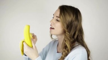 Lezzetli bir muz soyma ve yemek güzel genç kadın