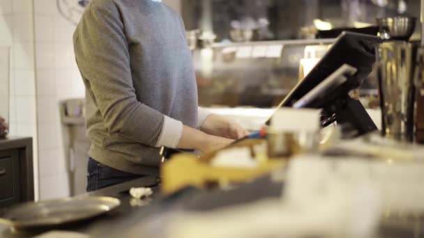 Woman bartender working with a cash register in a bar — Stock Video