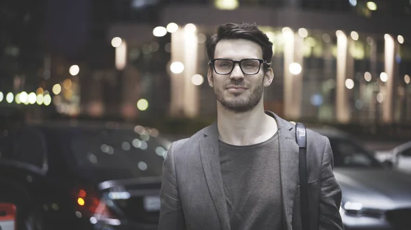 Un primo piano di un uomo barbuto per strada di notte — Foto Stock