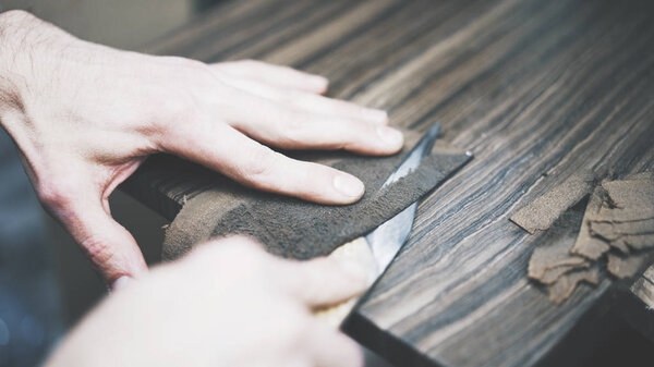 The process of cutting a leather with a knife