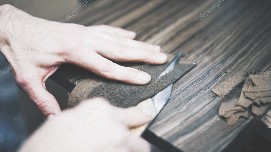 The process of cutting a leather with a knife