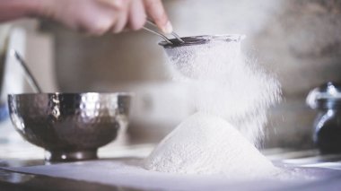 Bir kadın bir elek ile bir un Eleme