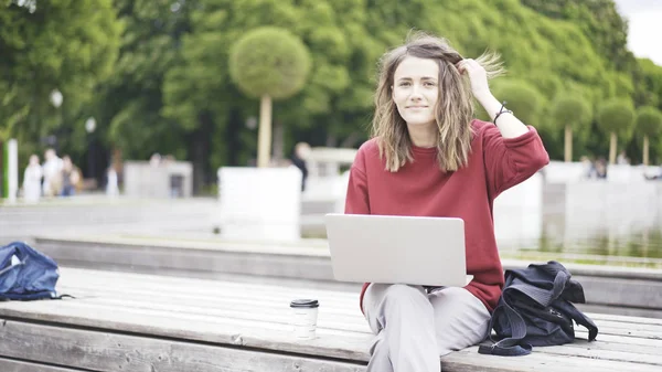 Sıradan bir genç kız parkta bir dizüstü bilgisayar ile — Stok fotoğraf
