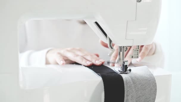 Unrecognizable woman sewing at a sewing machine, slow motion — Stock Video